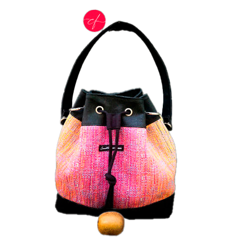 A shoulder bag made from mirror gradient woven wrap in pink to blue and black cork.