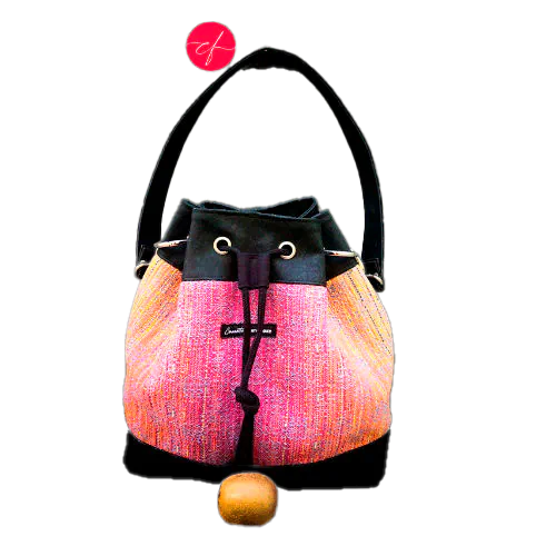 A shoulder bag made from mirror gradient woven wrap in pink to blue and black cork.