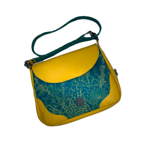 A messenger bag crafted from baby wrap fabric featuring yellow succulents on a turquoise background and sunshine-yellow leather, paired with ice-blue and yellow cotton linings inside.