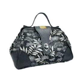 A mini handbag made of black, white, gray, and gold upholstery fabric, combined with anthracite and silver leather.