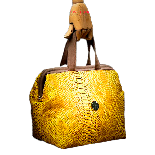 A handbag made with crocodile-textured yellow and brown synthetic leather.
