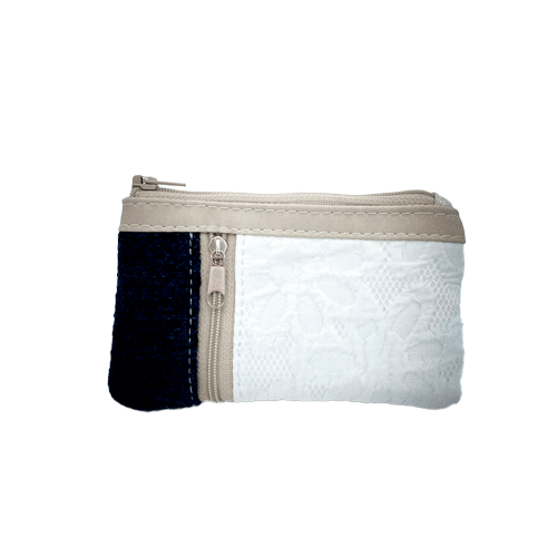 A mini zippered coin purse made from navy blue knitted pullover and white damask fabric.