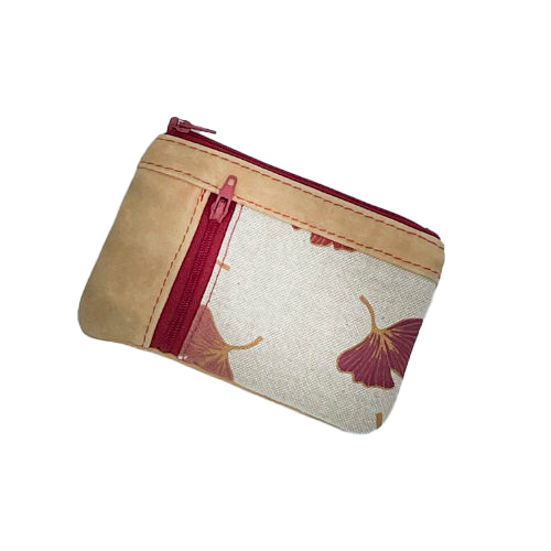 A mini zippered coin purse made of camel colored leather and a red Ginkgo Biloba leaves patterned polycotton canvas.