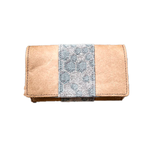 A wallet made of brown washable paper and a gray babywearing wrap with a hive pattern.
