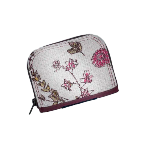 A small zippered card and coin holder made with fabric from a floral-patterned wrap in shades of pink on an ecru background and brick cork.
