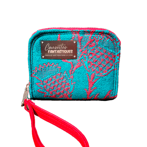 A small zippered card and coin holder made from blood-red and emerald green wrap fabric with thistle patterns and emerald green linen. It comes with a bright red faux leather wrist strap.