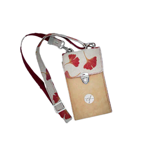 A phone-purse made from camel colored leather and a red Ginkgo Biloba leaves patterned polycotton canvas.