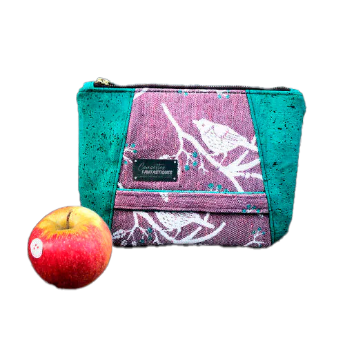 A zippered pouch sewn from a mauve and green babywearing wrap with a bird motif on branches, combined with emerald green cork.