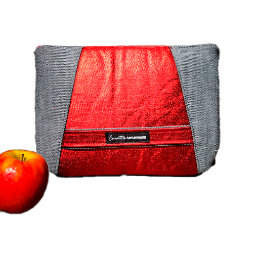 A zippered pouch sewn in gray reversible denim and metallic red, combined with bright red silk.