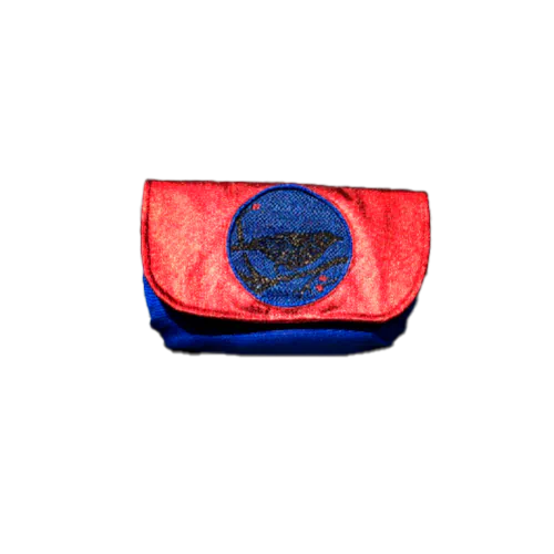 A small flap clutch sewn in blue canvas, metallic red-coated denim, and a glittery avian patterned babywearing wrap, lined with golden satin.