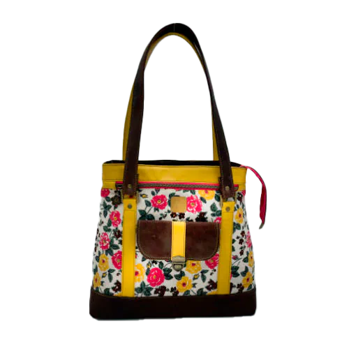 A shoulder bag made from chocolate and yellow leathers combined with a floral canvas featuring pink and yellow flowers.
