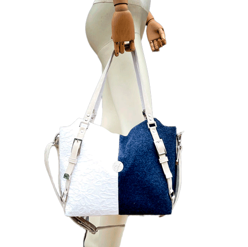 A shoulder bag made from navy wool and white cotton damask.