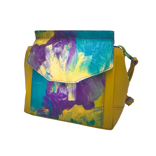 An angular bag made from yellow leather and a hand-painted damask fabric, lined with turquoise and violet satins.