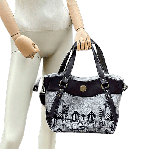 A shoulder bag made with midnight blue and silver geometric Art Deco wrap fabric, and midnight blue leather.