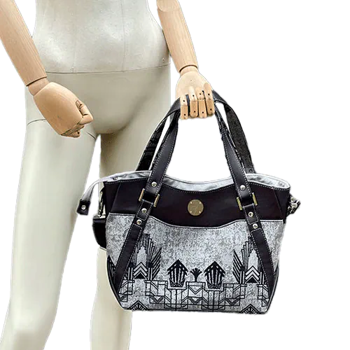 A shoulder bag made with midnight blue and silver geometric Art Deco wrap fabric, and midnight blue leather.