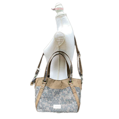 A shoulder bag made from gray babywearing wrap with a beehive and bees pattern, and brown washable paper.