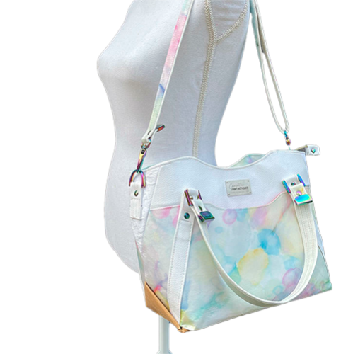 A shoulder bag made from various materials: white synthetic material, hand-painted silk scarf, and white cotton damask.