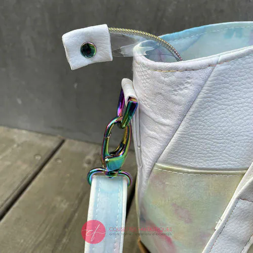 A shoulder bag made from various materials: white synthetic material, hand-painted silk scarf, and white cotton damask.