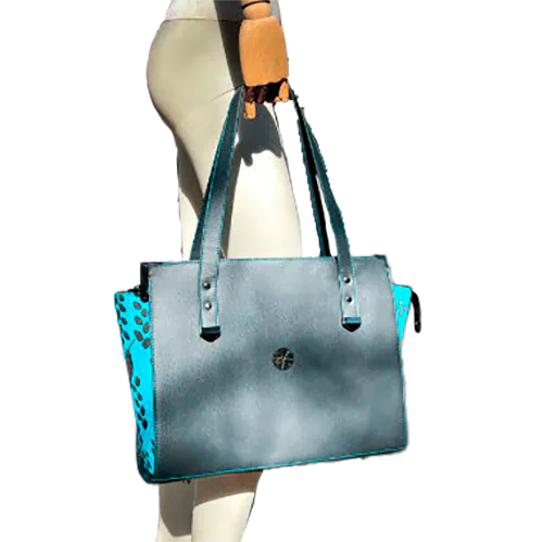 A shoulder bag made of turquoise babywearing fabric with hummingbird and petal motifs, combined with gray and turquoise imitation leather.