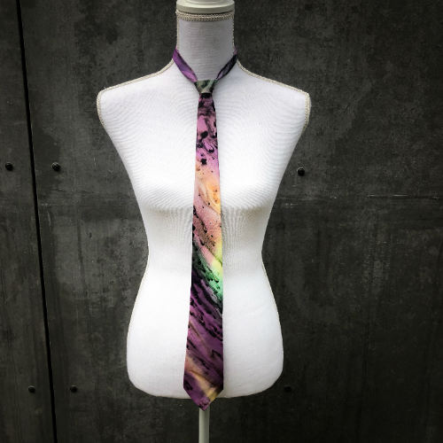 A tie made of blue, green, and purple silk chiffon, lined with taupe ramie.