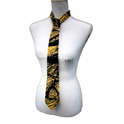 A tie made from black and gold woven wrap, marbled pattern.