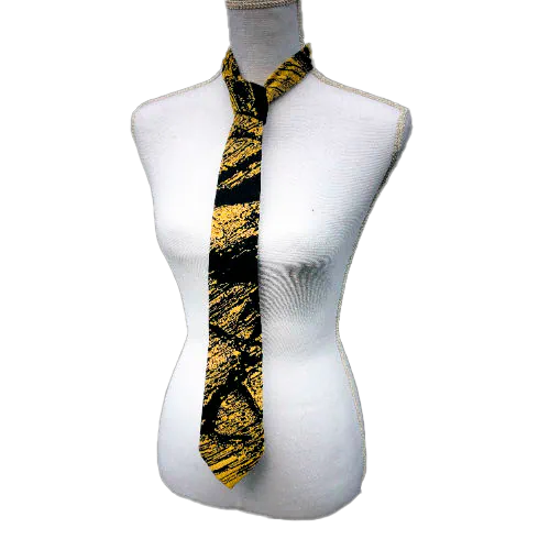 A tie made from black and gold woven wrap, marbled pattern.