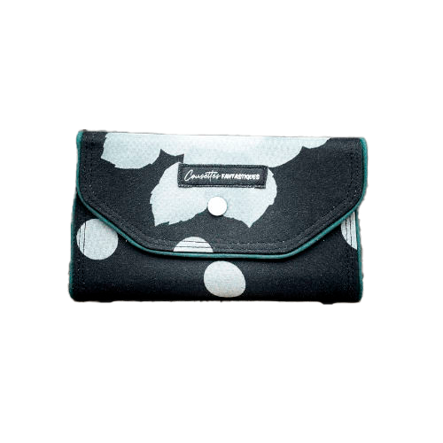 A wallet made from black and white floral silk chiffon on the outside and black poplin on the inside.