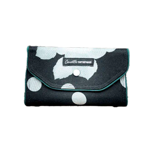 A wallet made from black and white floral silk chiffon on the outside and black poplin on the inside.