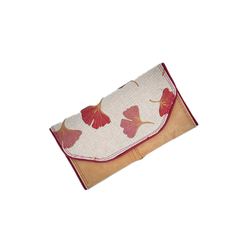 A wallet made from camel colored leather and a red Ginkgo Biloba leaves patterned polycotton canvas.