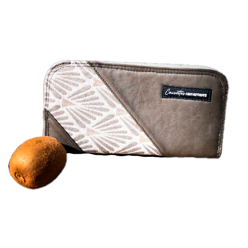 A zippered card and coin holder made with gray lamb leather, upholstery fabric, and raw linen canvas.