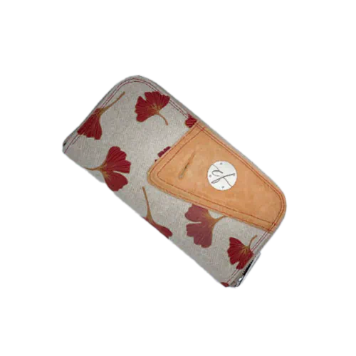 A zippered card and coin holder made with camel colored goat leather and a red Ginkgo Biloba leaves patterned polycotton canvas.