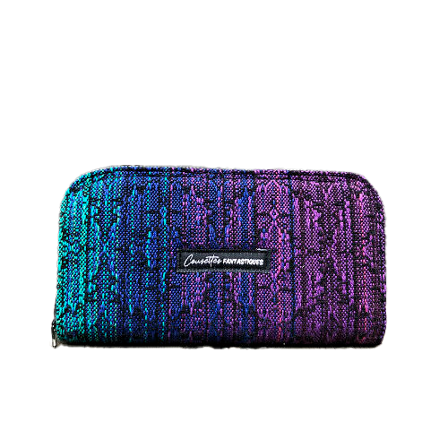 A wallet made with a babywearing wrap in a gradient from blue to violet on the outside and black, pink, and petrol poplin on the inside.