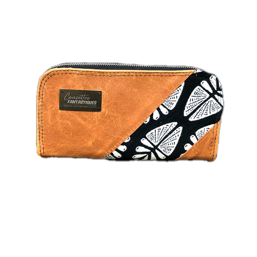 A wallet made from a babywearing wrap in a gradient from blue to violet on the outside and black, pink, and petrol poplin on the inside.