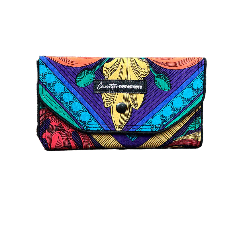 A wallet made from black and white floral silk chiffon on the outside and black poplin on the inside.