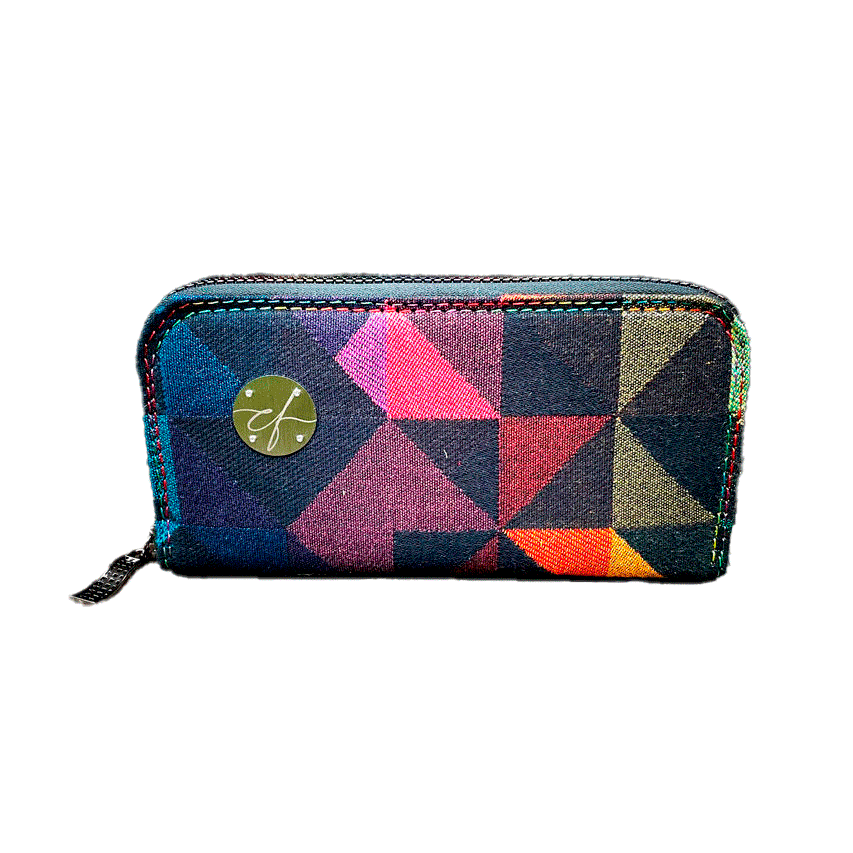 A zippered card and coin holder made from a black and rainbow babywearing wrap with a geometric pattern, royal blue poplin interior.