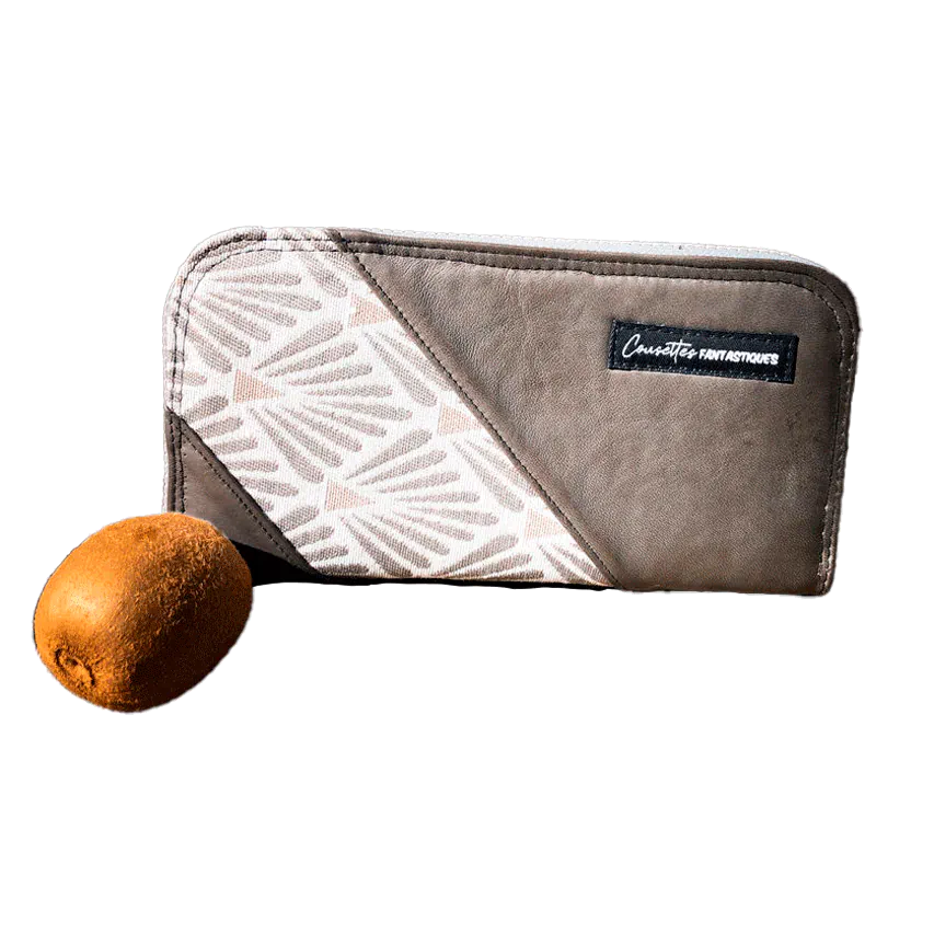 A zippered card and coin holder made with gray lamb leather, upholstery fabric, and raw linen canvas.
