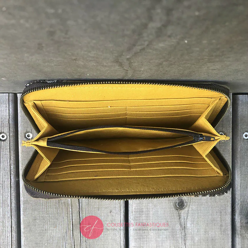 A zipped wallet and cardholder made of chocolate brown washable paper, baby wrap fabric in brown and beige tones, and yellow poplin.