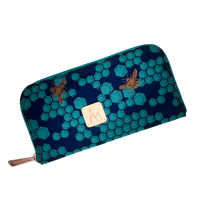 A zippered card and coin holder made with dark blue and petrol blue honeycomb patterned babywearing wrap fabric with bees.