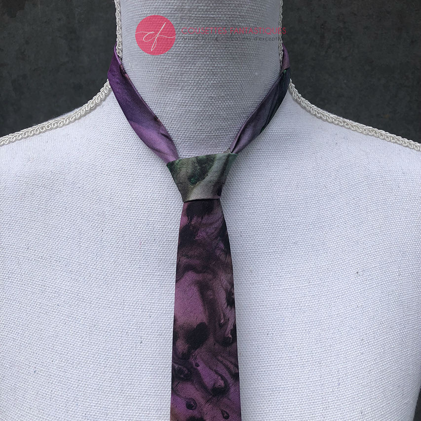 A tie made of blue, green, and purple silk chiffon, lined with taupe ramie.