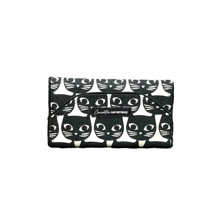 Un portefeuille fait de toile de coton noir et blanc à motif de têtes de chat à l'extérieur, et de popeline rose et de cretonne à motifs d'oiseaux à l'intérieur.