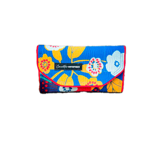 Un portefeuille fait en toile bleue roi à motifs floraux jaunes, blancs et rouges à l'extérieur et toiles unies jaune et rouge à l'intérieur.