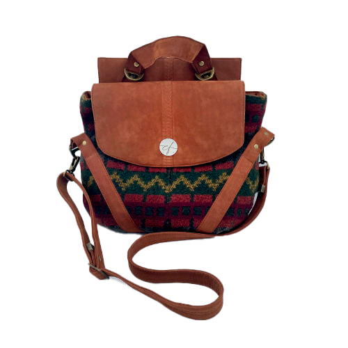 Un sac de taille moyenne, porté épaule, main, bandoulière ou dos, en suédine alezan et drap laine au motif géométrique, avec une doublure en viscose molletonée motif géométrique.